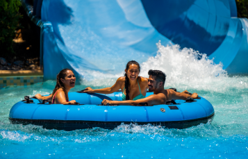 Three people on a water slide