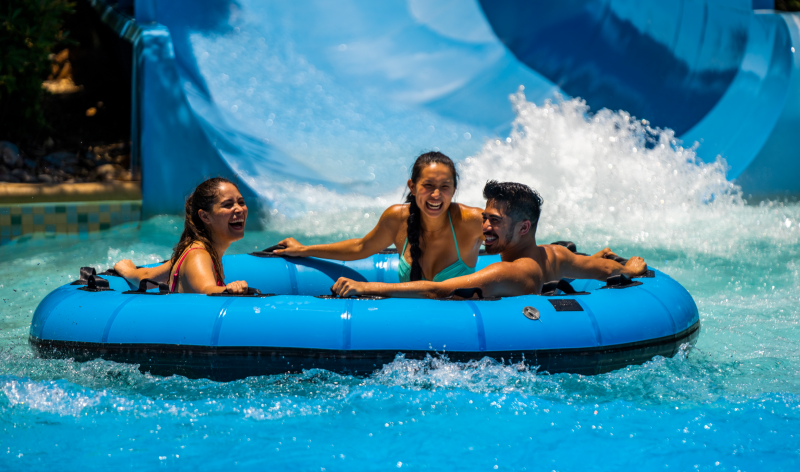 Three people on a water slide