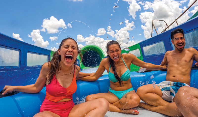 Three people on a water slide