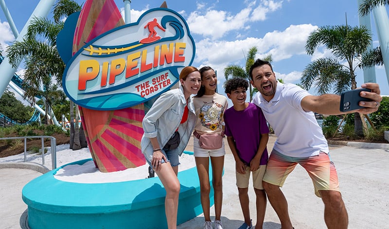 Guests taking a selfie in front of the Pipeline sign