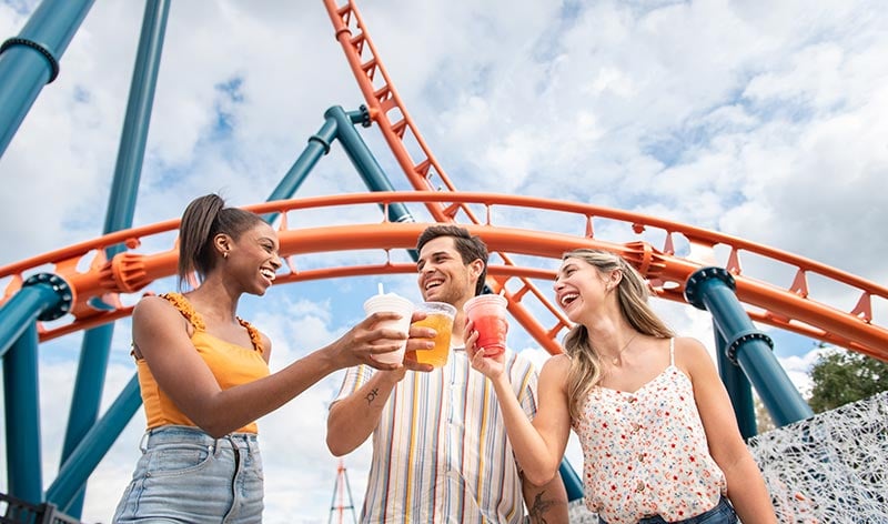 Guests cheers beer in front of Ice Breaker roller coaster at SeaWorld