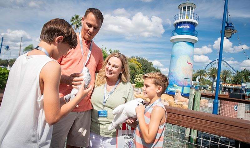 Family standing near the SeaWorld lighthouse entrance