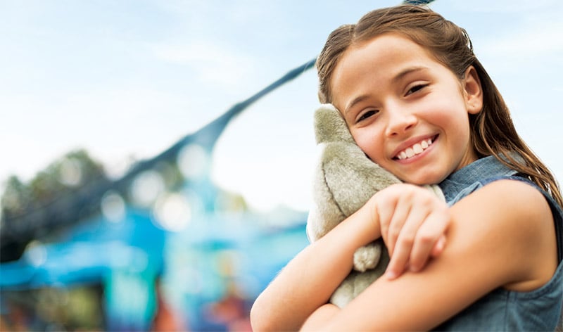 Girl hugging plush toy