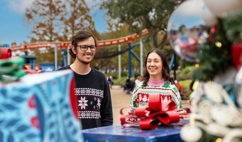 Two friends wearing holiday sweaters