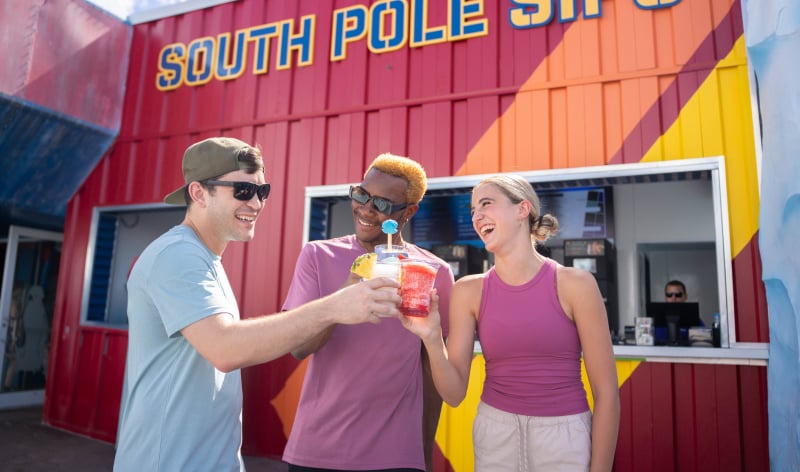 Three people with drinks outside of South Pole Sips at SeaWorld San Diego