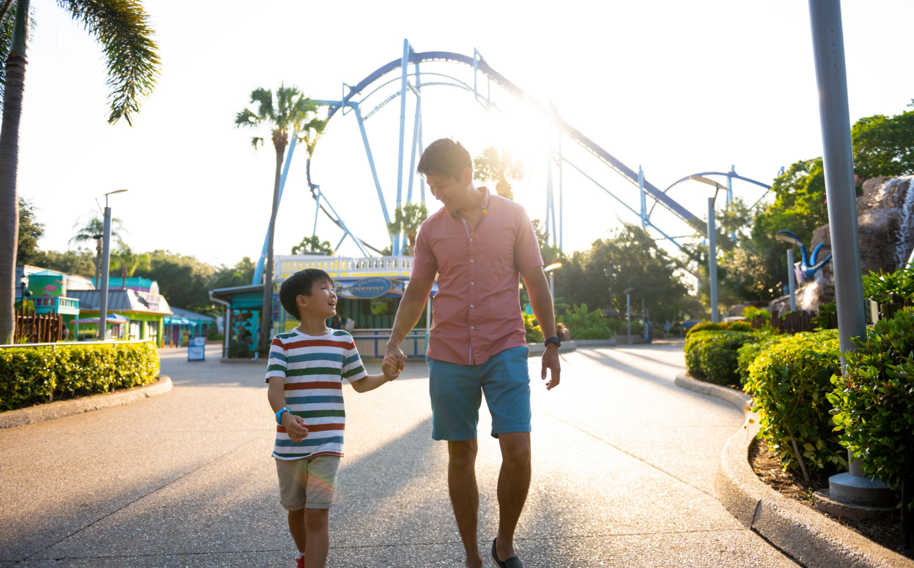 Child and adult holding hands at SeaWorld Orlando