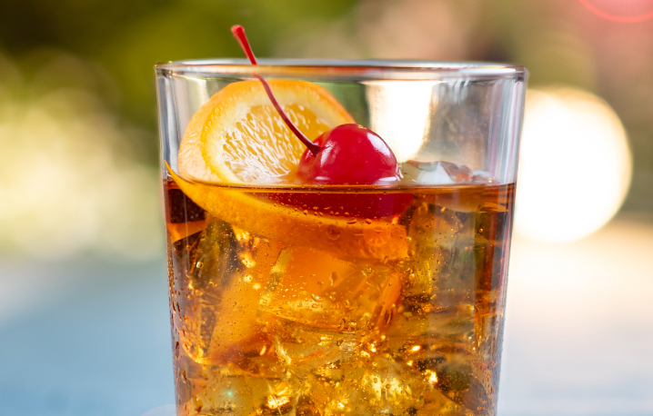 Cocktail with an orange slice and a cherry