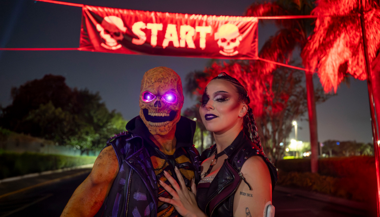 Two Halloween scare actors at a race start line