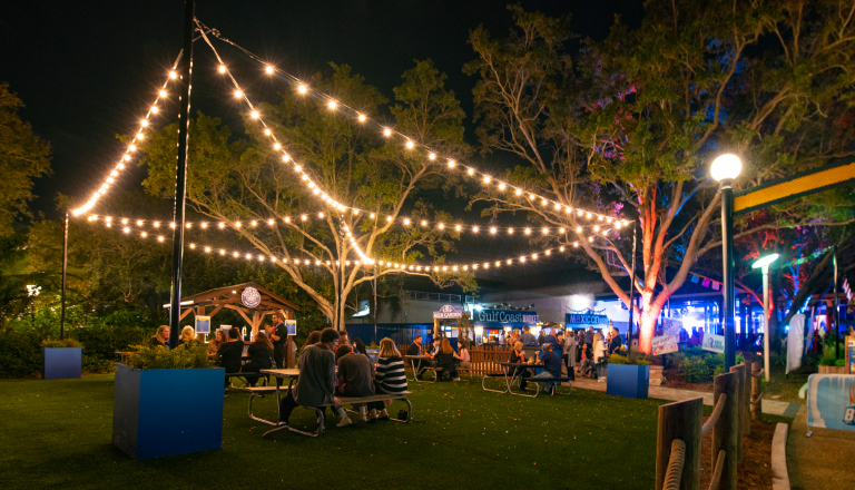 Outdoor event space at night with string lights