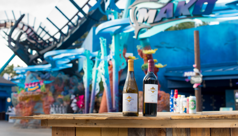 A lineup of wine in front of Mako ride entrance