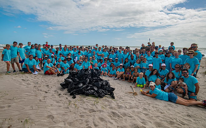 Volunteers and items cleared from beach during Pass Member Beach Cleanup