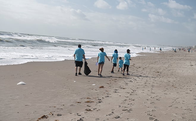 Volunteers cleaning beach during Pass Member Beach Cleanup