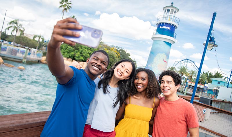 Teens taking a selfie at the SeaWorld Orlando lighthouse entrance