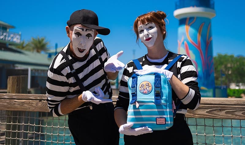 The SeaWorld Mimes holding a retro Clyde and Seamore Loungefly Bag