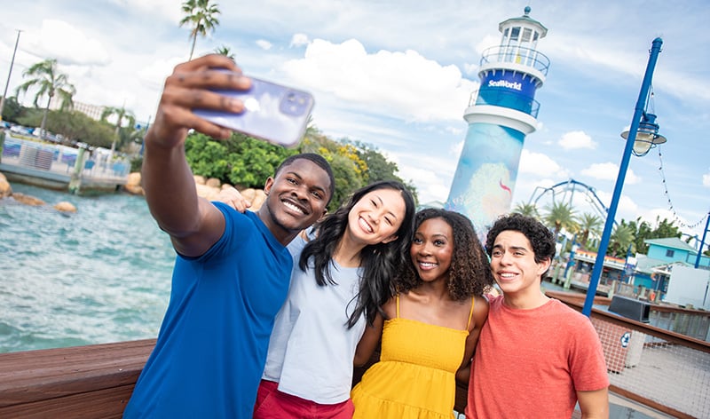 Group selfie in front of SeaWorld Orlando lighthouse