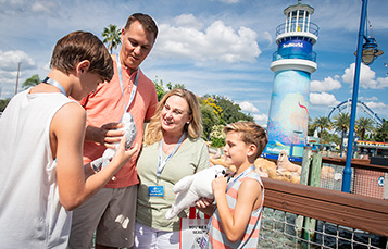 Family near SeaWorld lighthouse entrance