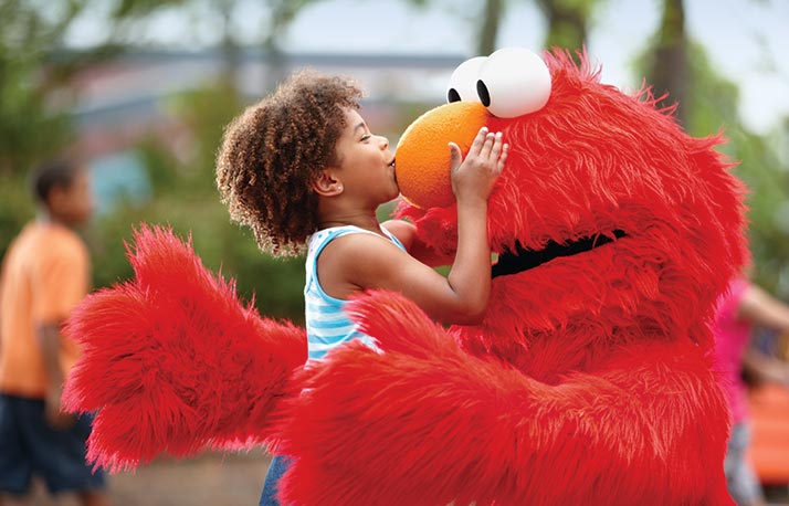 Little girl kissing Elmo