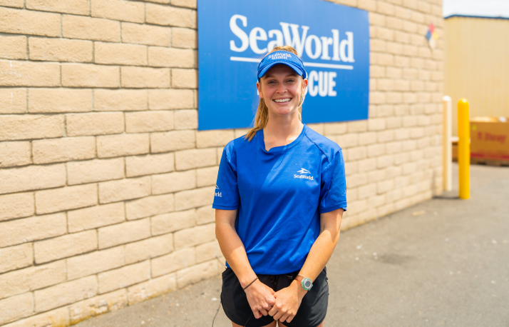 Zookeeper in front of SeaWorld sign