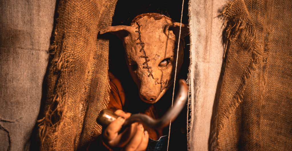 Scare actor in a pig mask