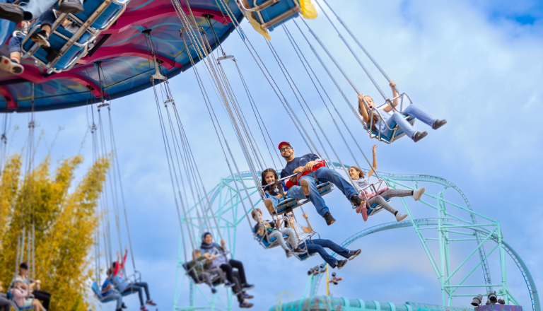 People riding a swinging ride
