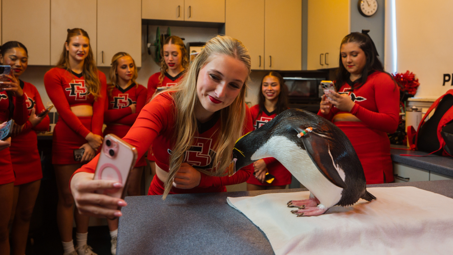 Cheerleaders with a penguin