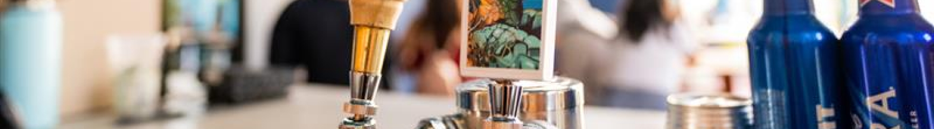 Two bar taps and two bottles of beer