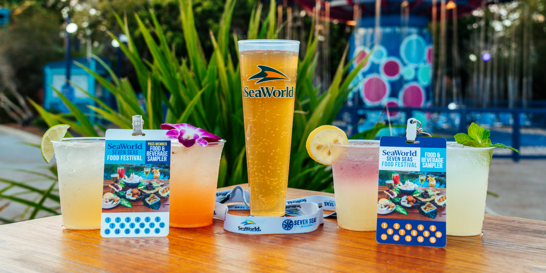 Flight of colorful drinks with SeaWorld San Diego food sampler lanyards