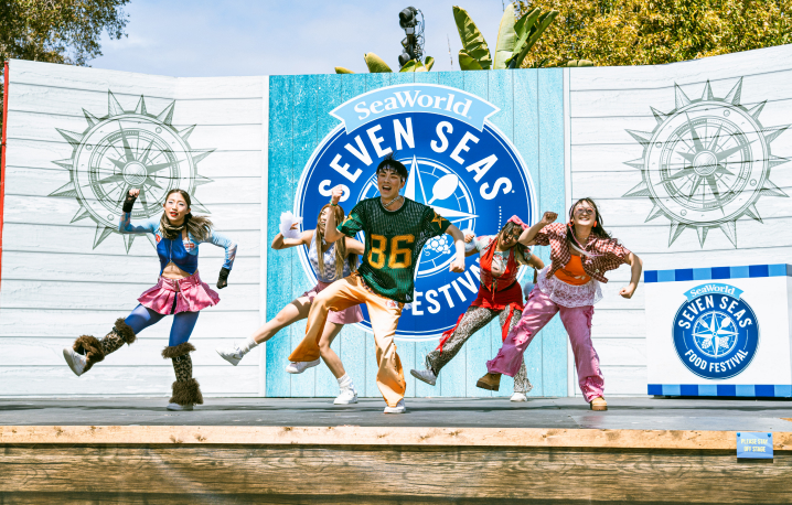 Five people dancing on a stage