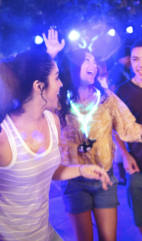 Group of people dancing in black light