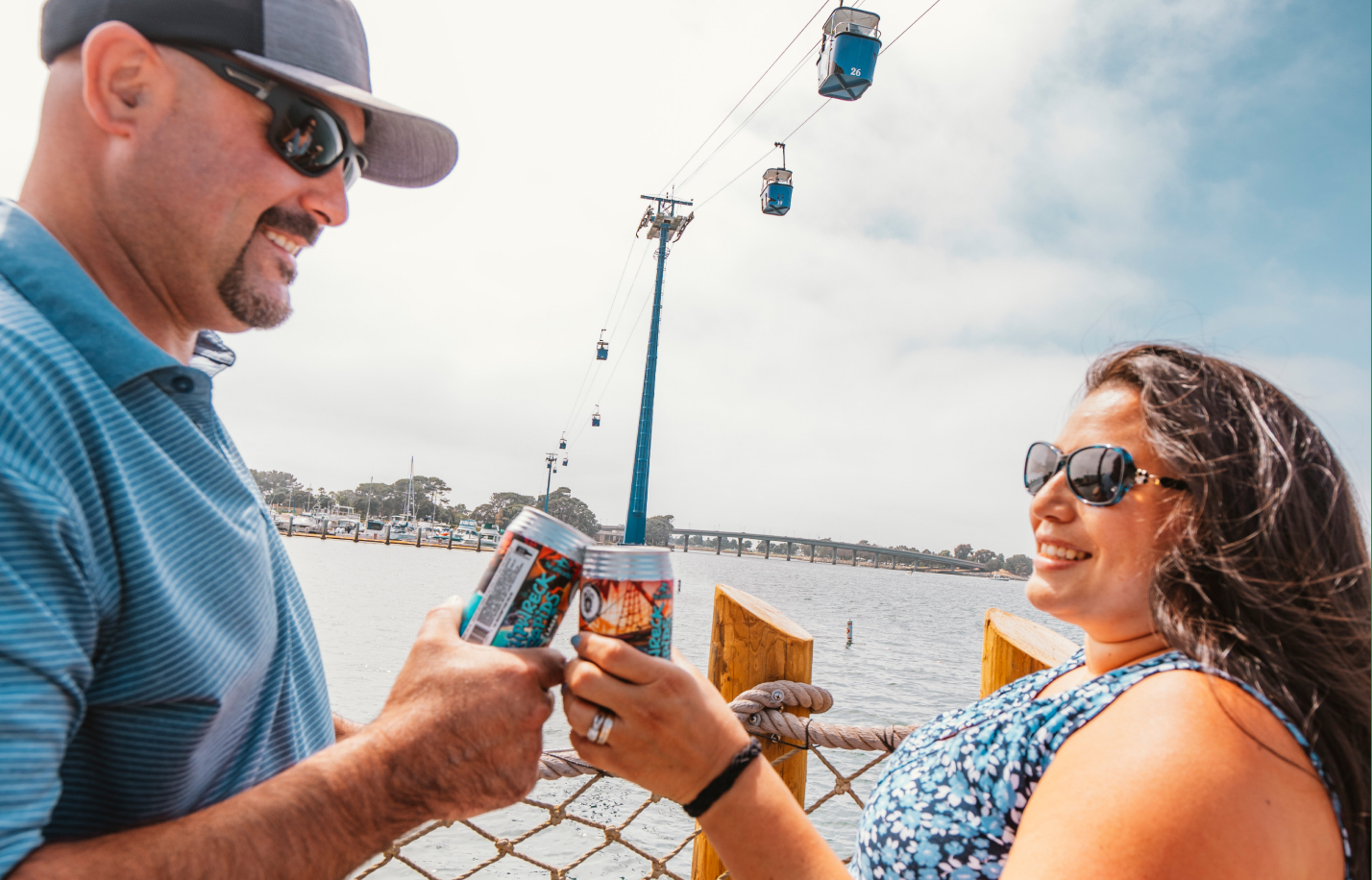 Man and woman clinking beer cans