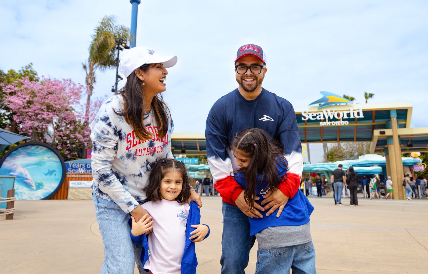 Family of four in front of SeaWorld sign