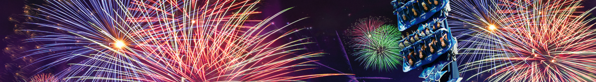 Fireworks behind a roller coaster