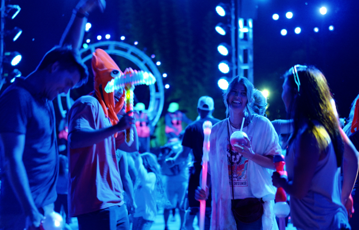 People dancing under colored lights