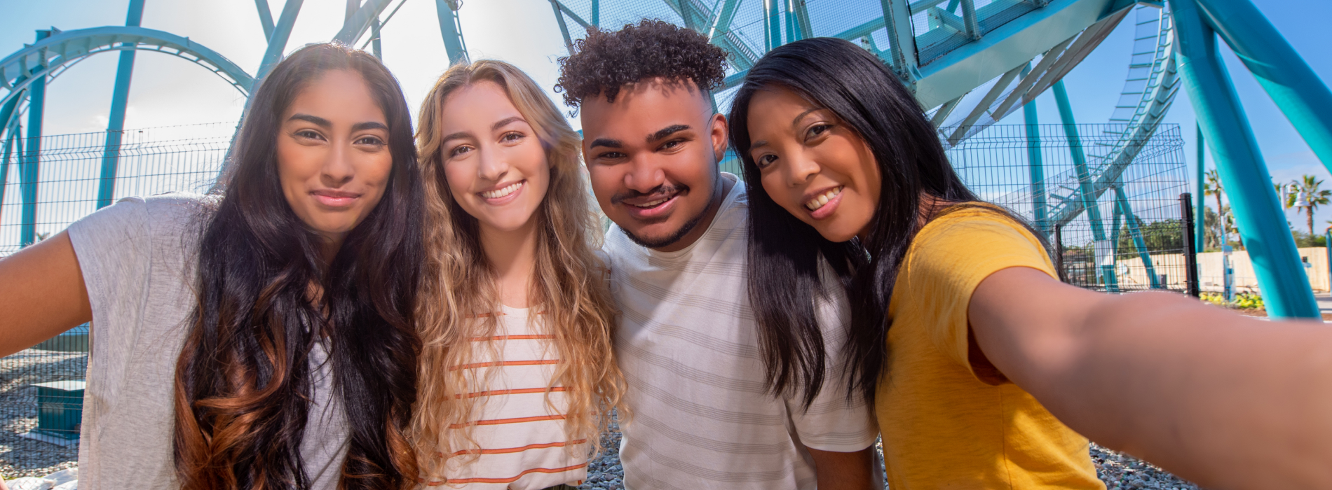 Group of friends in front of a roller coaster