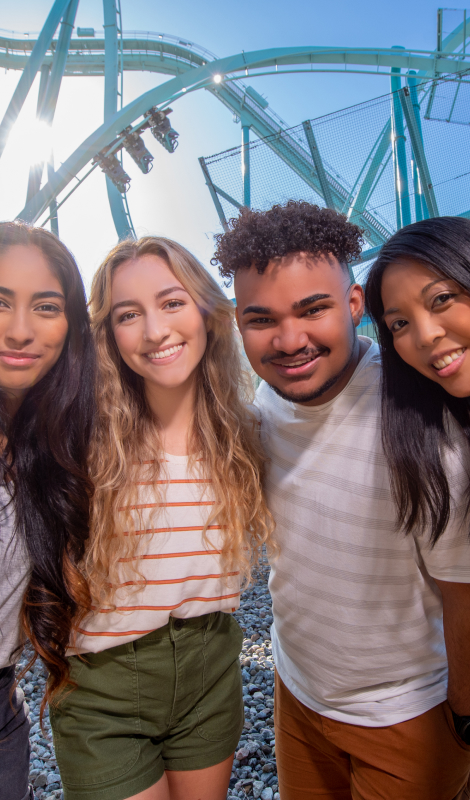 Group of friends in front of a roller coaster