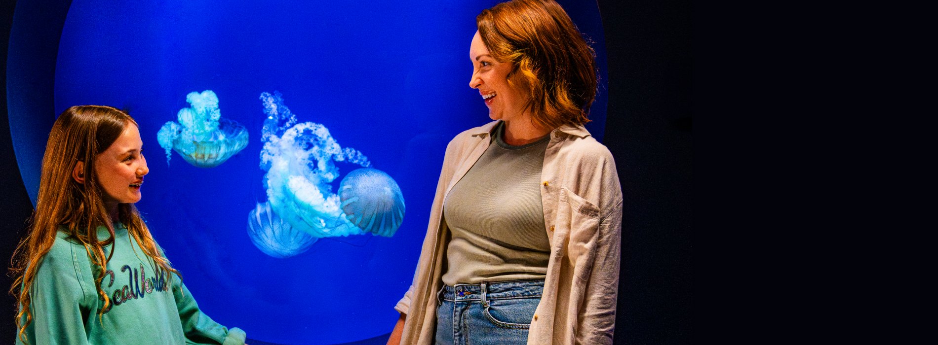 Woman and child looking at jellyfish